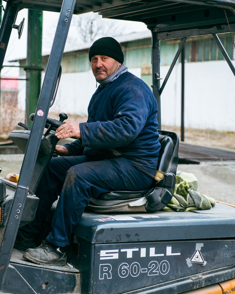 A forklift driver loading aid into vehicles headed for Ukraine 
